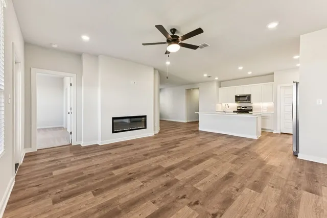a view of a hallway with a kitchen
