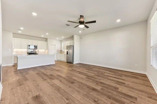 a view of a kitchen with a sink and a refrigerator