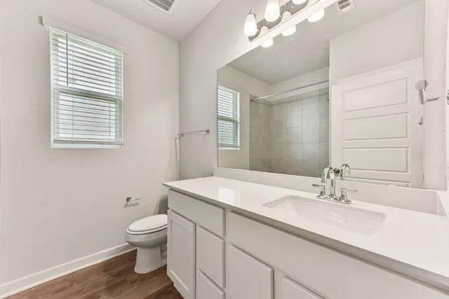 a bathroom with a sink a toilet and large mirror