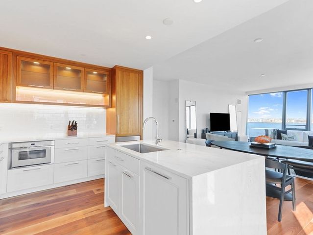 a kitchen with a sink a stove and a refrigerator