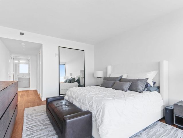 a bedroom with a large bed and a couch