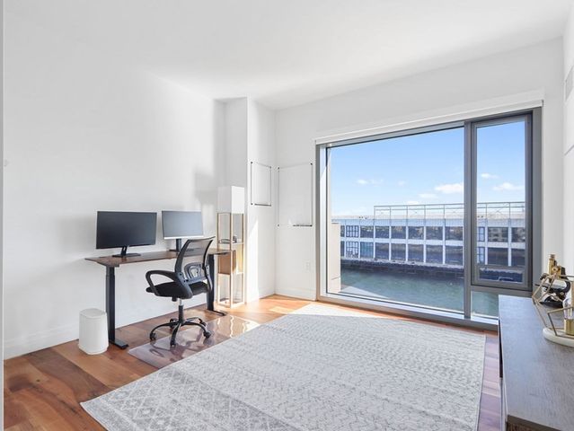 a livingroom with workspace and a window