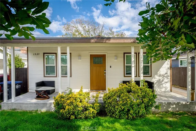 a front view of a house with garden