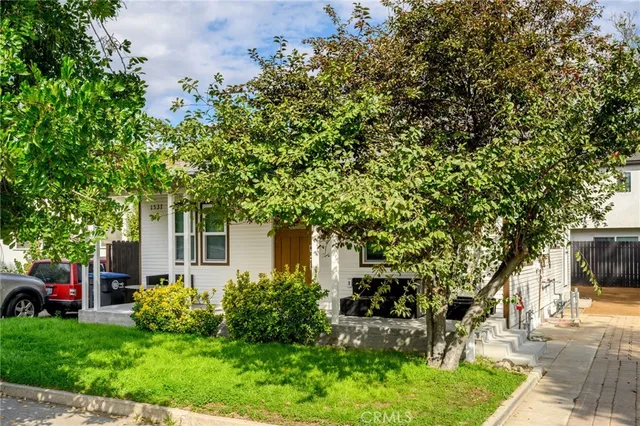 a front view of a house with garden