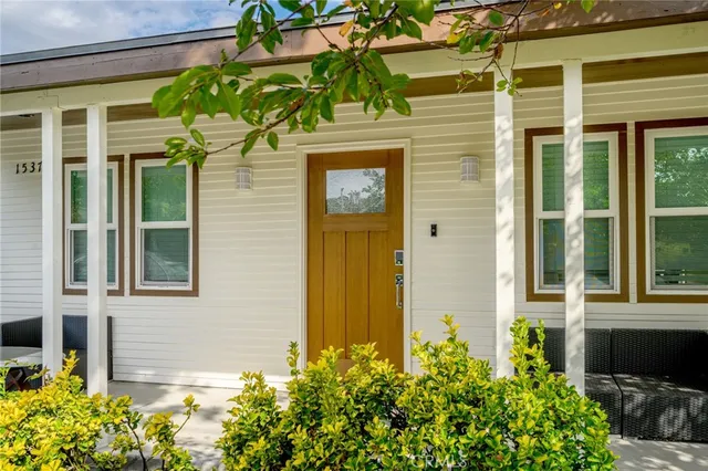front view of a brick house with a large window