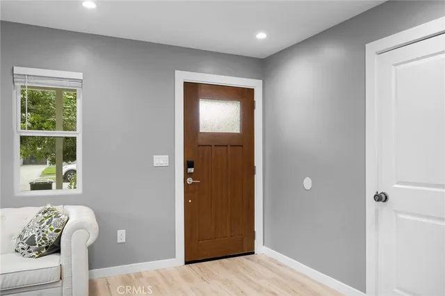 a view of entryway with window and wooden floor