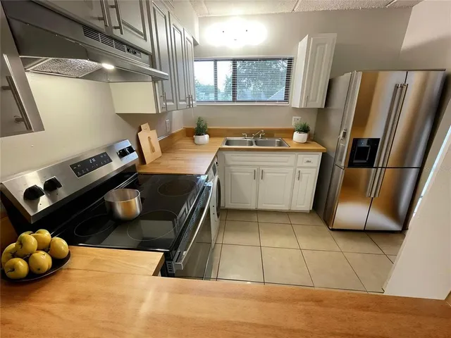 a kitchen with a sink and a refrigerator