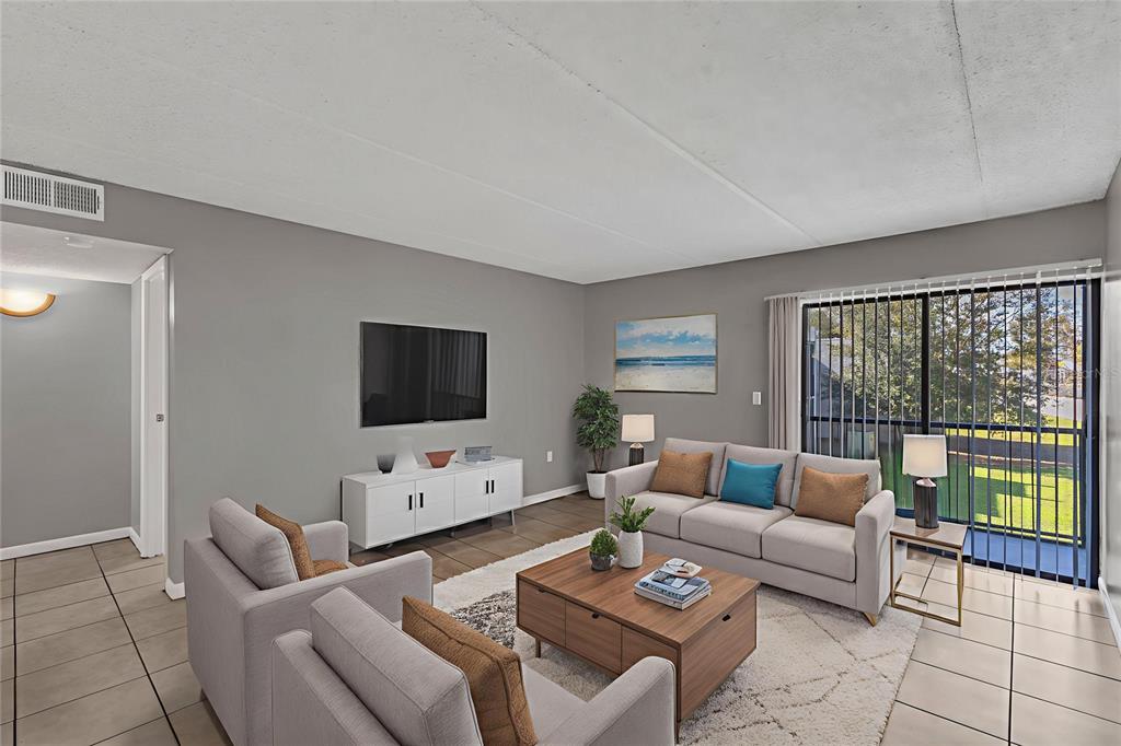 1108 Bartow Road, Unit 107 Lakeland, FL 33801 - Photo 6 of 12 a living room with furniture and a flat screen tv