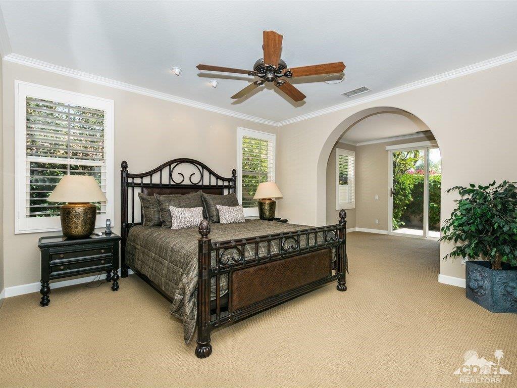 285 Loch Lomond Road Rancho Mirage, CA 92270 - Photo 13 of 48 a bedroom with a bed and a chandelier