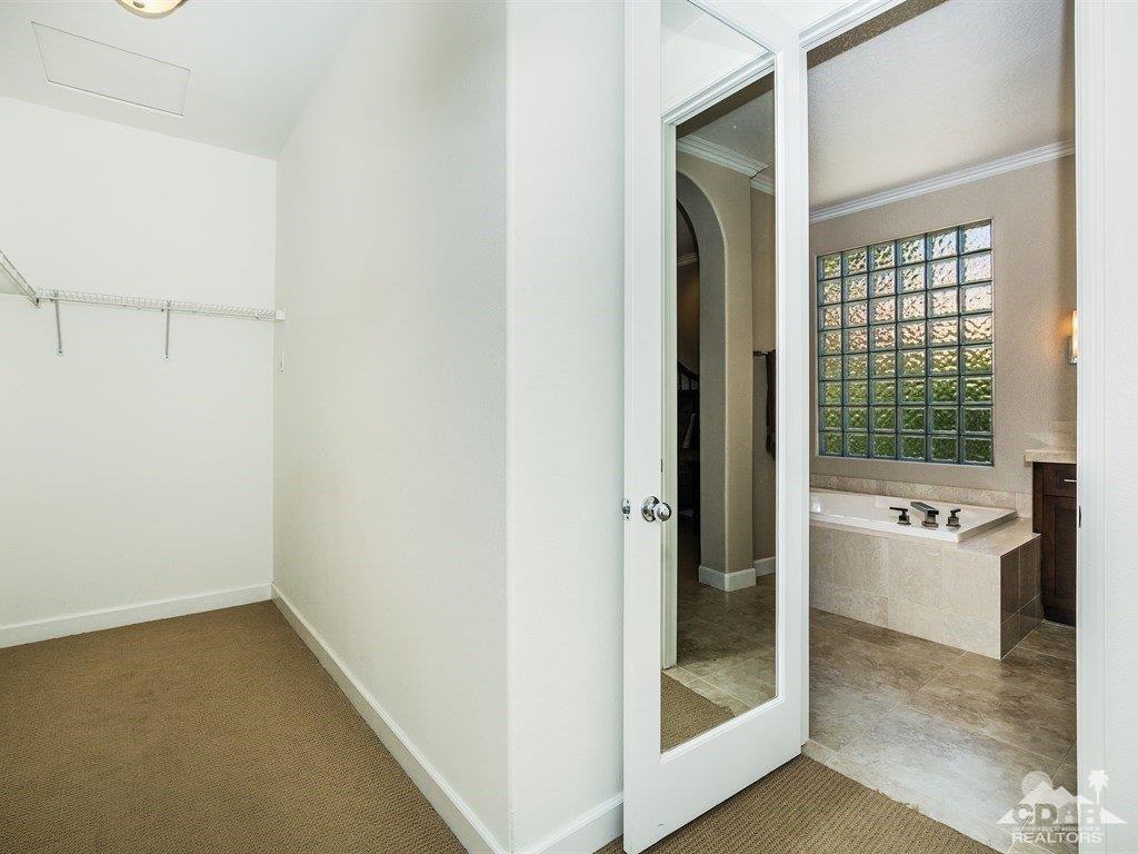 285 Loch Lomond Road Rancho Mirage, CA 92270 - Photo 20 of 48 a view of a bathroom with a tub shower and sink
