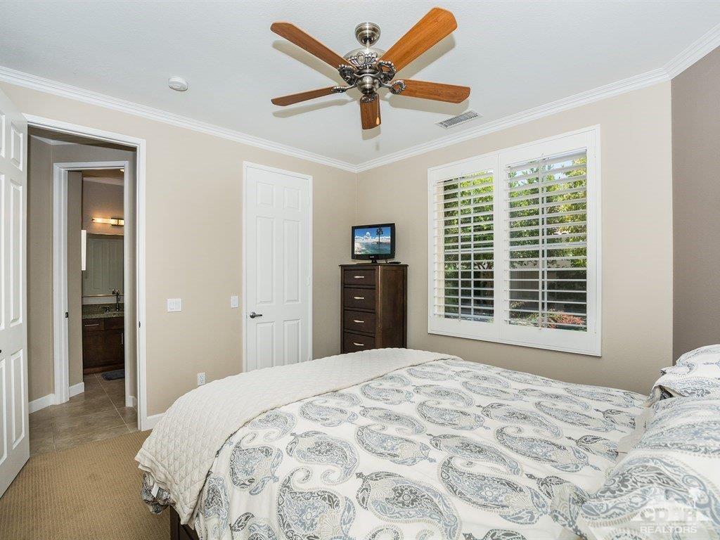 285 Loch Lomond Road Rancho Mirage, CA 92270 - Photo 22 of 48 a bedroom with a large bed and a large window