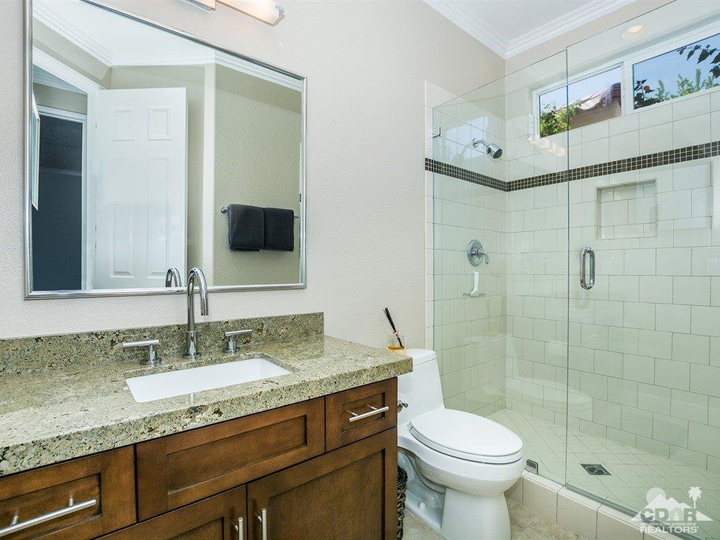 285 Loch Lomond Road Rancho Mirage, CA 92270 - Photo 23 of 48 a bathroom with a granite countertop sink toilet and shower