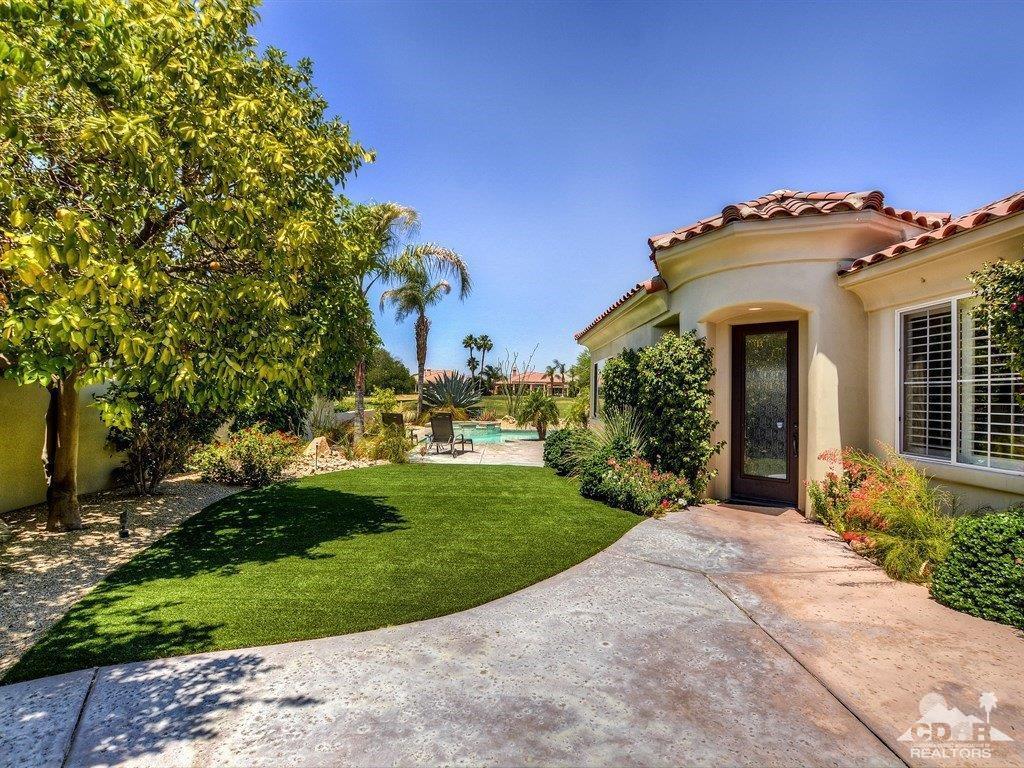 285 Loch Lomond Road Rancho Mirage, CA 92270 - Photo 43 of 48 a front view of a house with a yard and garage