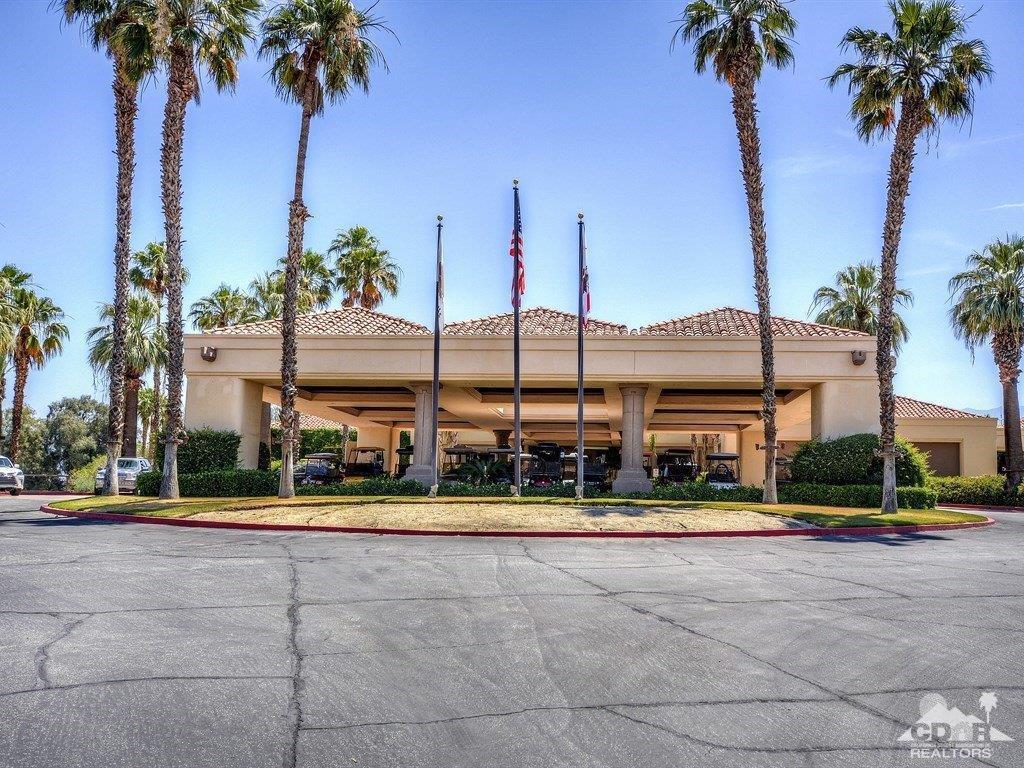 285 Loch Lomond Road Rancho Mirage, CA 92270 - Photo 47 of 48 a view of a tall palm tree with a yard and palm trees