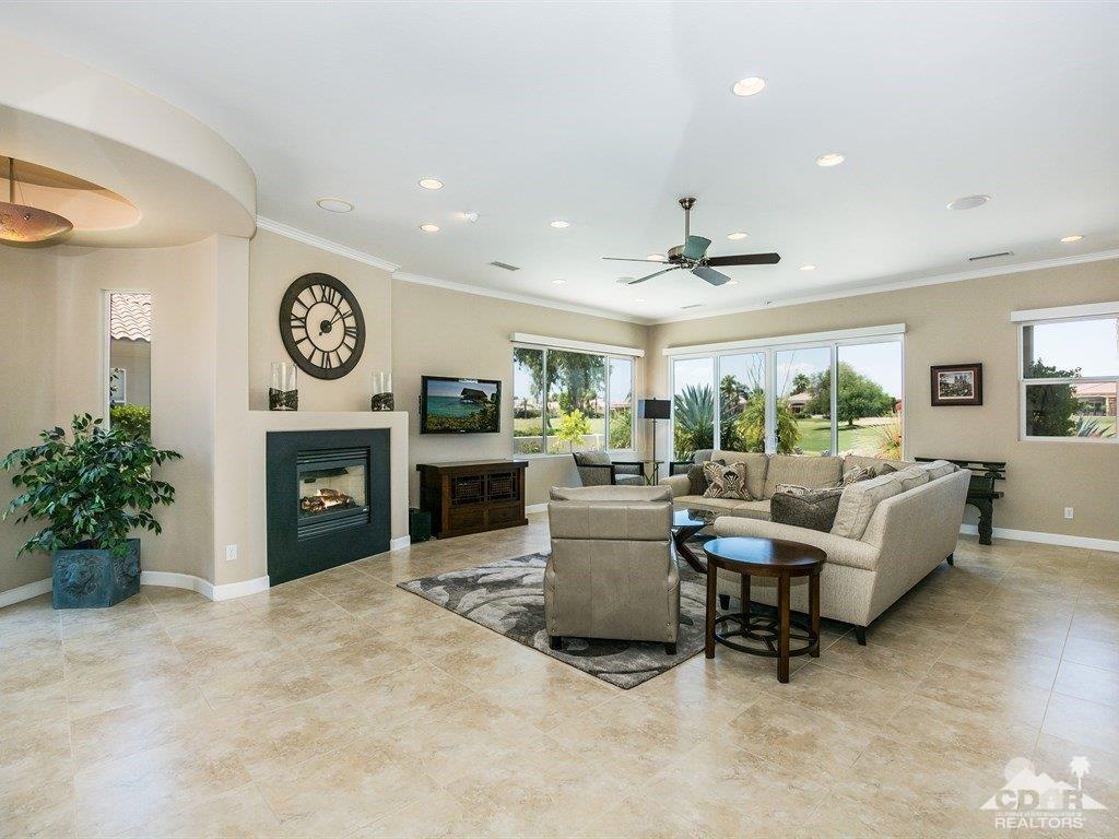 285 Loch Lomond Road Rancho Mirage, CA 92270 - Photo 5 of 48 a living room with furniture a fireplace and a large window