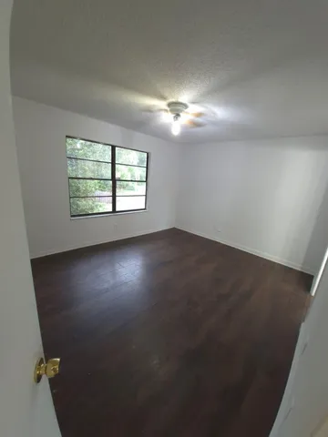 an empty room with a empty space and windows