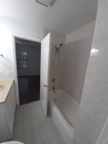 a spacious bathroom with a bathtub and a shower