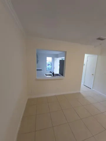 wooden floor in an empty room with a mirror