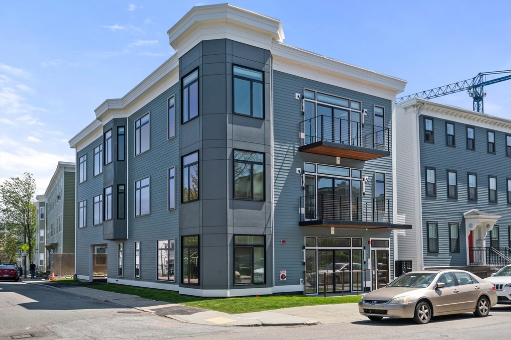 142 Pleasant Street Boston, MA 02125 - Photo 1 of 24 a front view of a building with lot of cars and trees