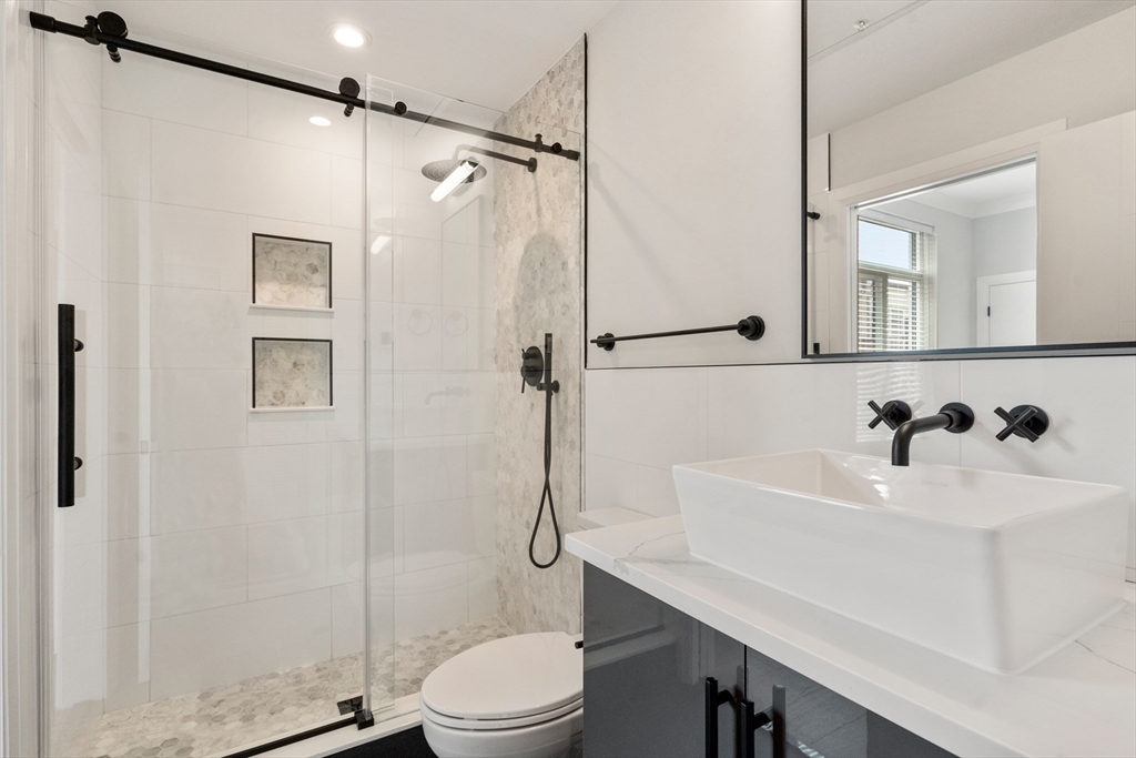 142 Pleasant Street Boston, MA 02125 - Photo 12 of 24 a bathroom with a sink toilet and shower