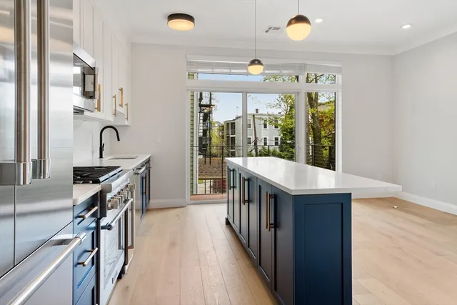 a kitchen with granite countertop a sink a counter top space appliances and cabinets