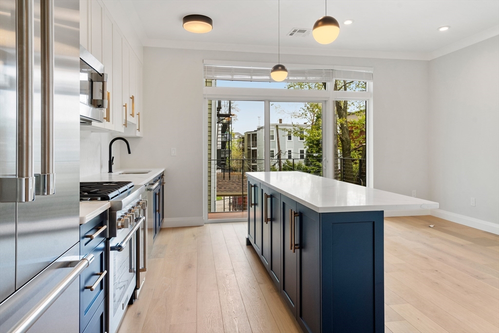 142 Pleasant Street Boston, MA 02125 - Photo 13 of 24 a kitchen with granite countertop a sink a counter top space appliances and cabinets