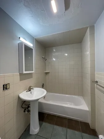 a bathroom with a sink a mirror and a bathtub