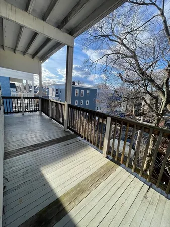 a view of balcony with wooden floor