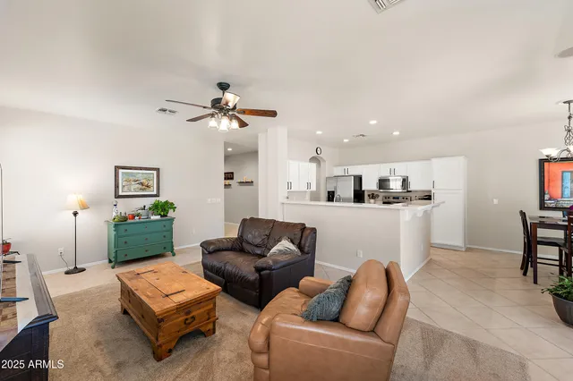 a living room with furniture ceiling fan and a rug
