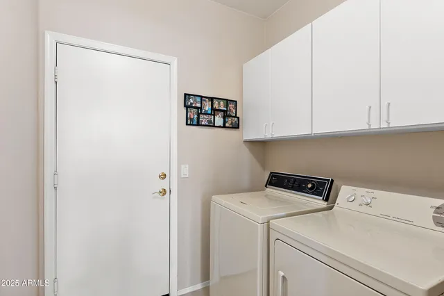 a view of storage and utility room with washer and dryer