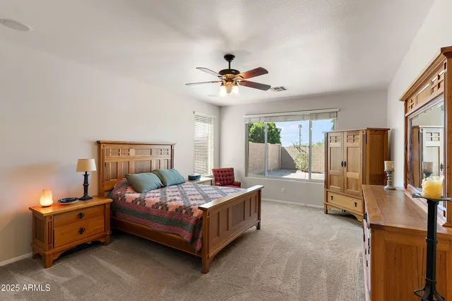 a bedroom with a bed dresser and a window