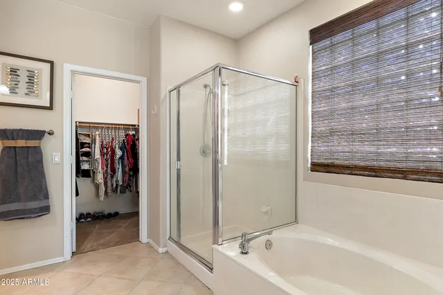 a bathroom with a shower and a tub