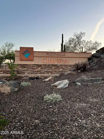 a view of a dry yard with wooden fence