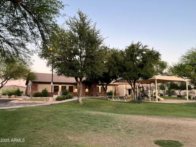 a front view of a house with a yard table and trees