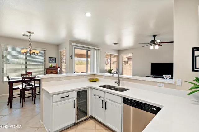 a kitchen with a sink and a stove top oven with wooden floor