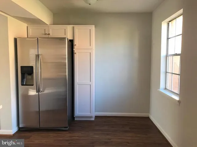 a view of a refrigerator in kitchen and wooden floor