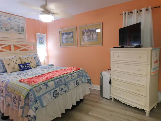 a bedroom with a bed and flat screen tv