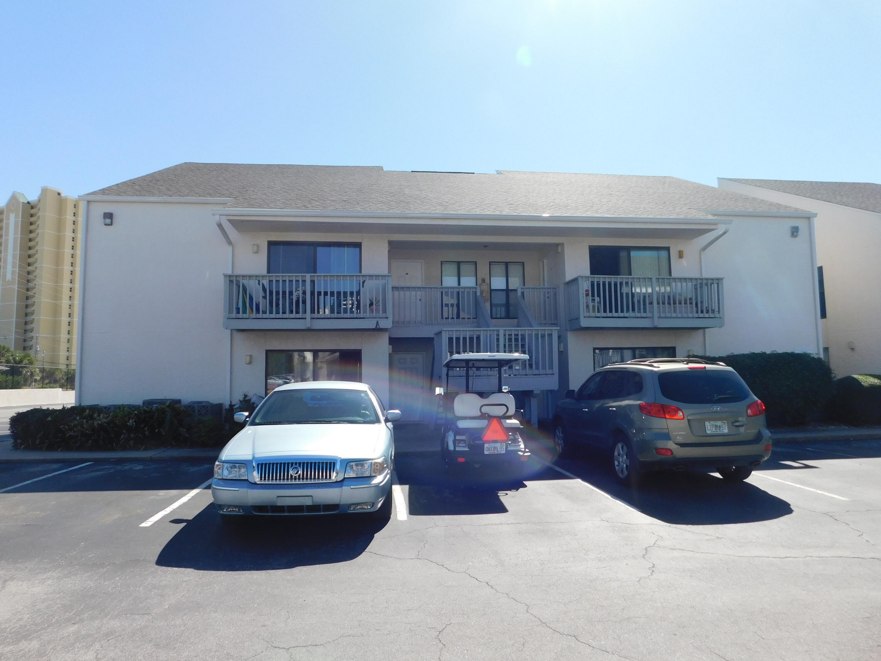 17614 Front Beach Road, Unit A38 Panama City Beach, FL 32413 - Photo 13 of 22 a car parked in front of a house