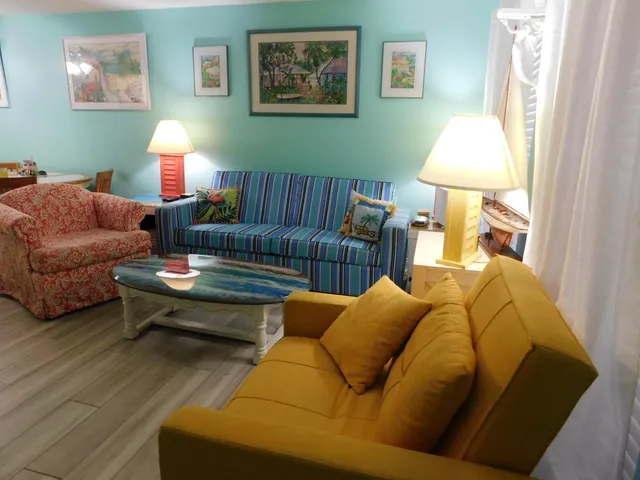 a living room with furniture a lamp and a window