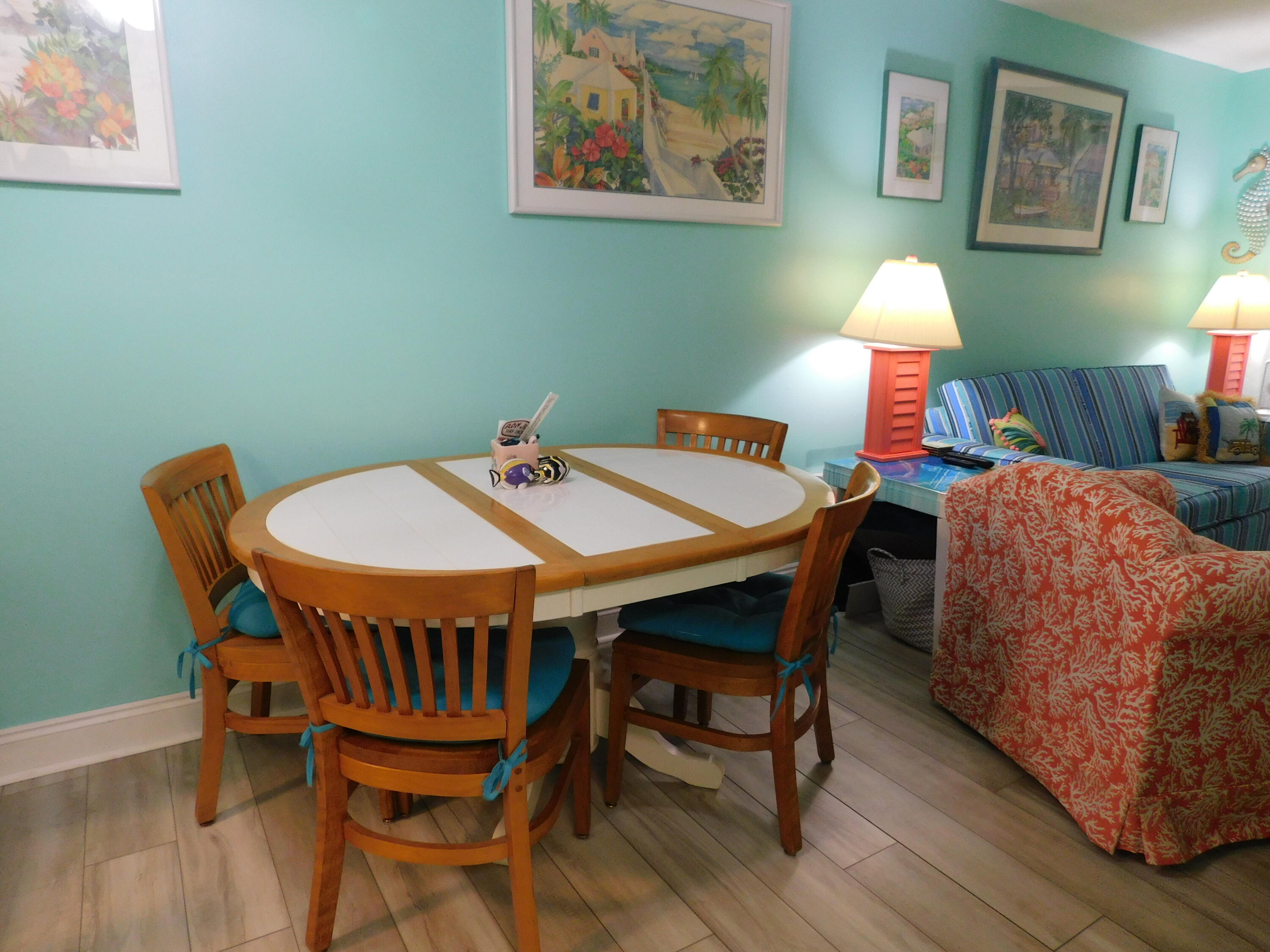 17614 Front Beach Road, Unit A38 Panama City Beach, FL 32413 - Photo 8 of 22 a dining room with a wooden table and chairs