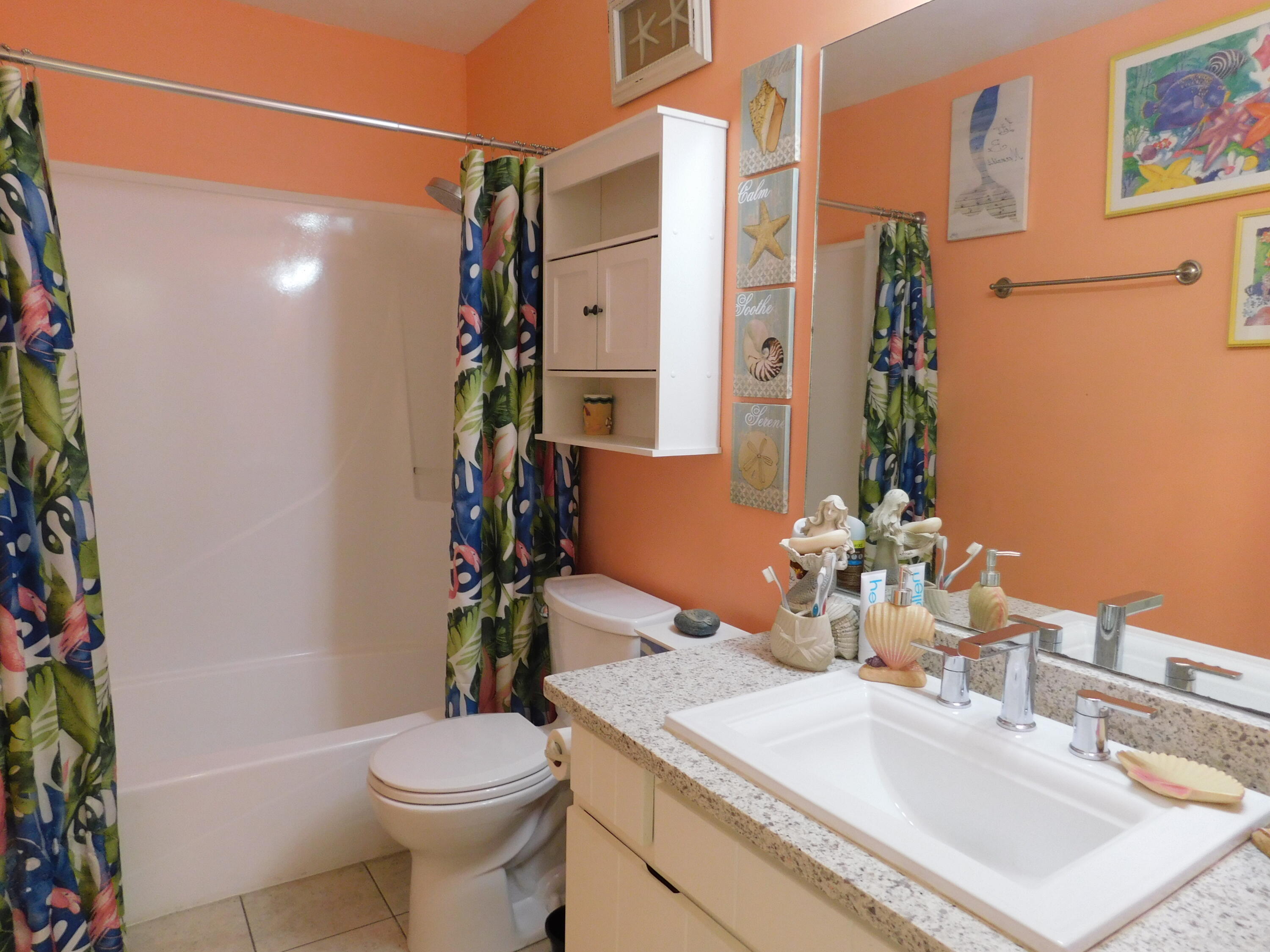17614 Front Beach Road, Unit A38 Panama City Beach, FL 32413 - Photo 10 of 22 a bathroom with a sink toilet and shower