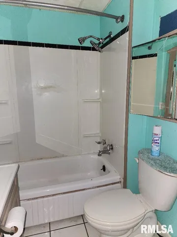 a bathroom with a toilet and a bathtub