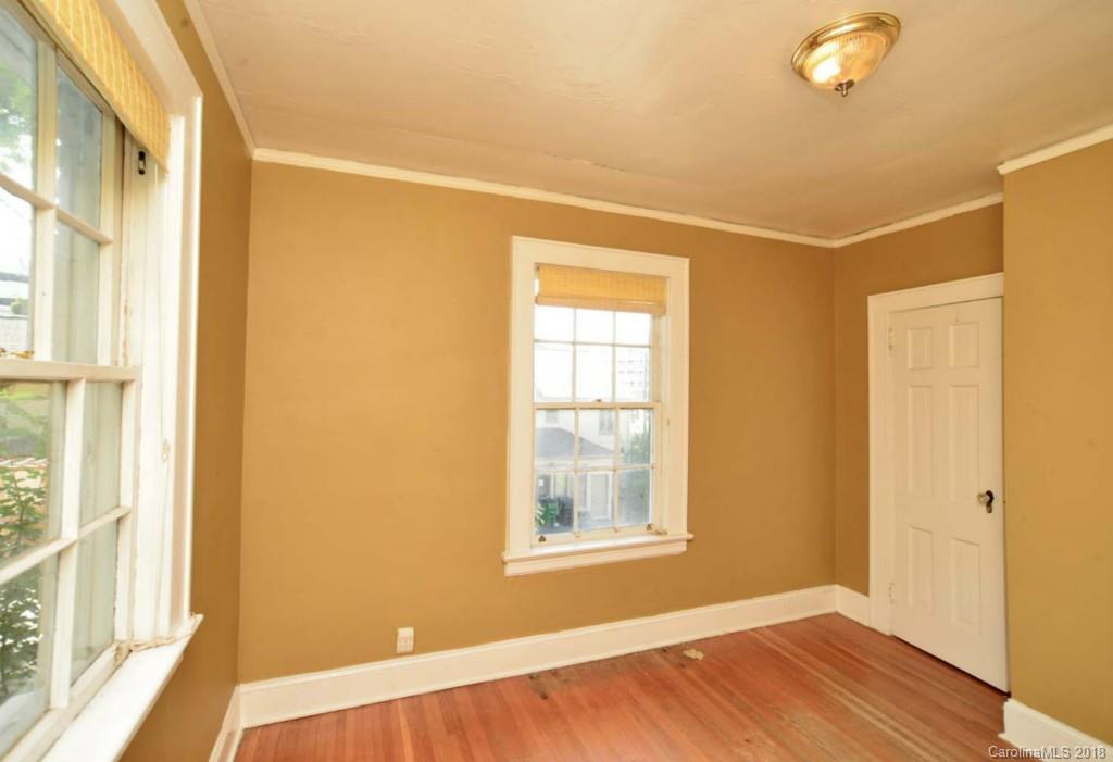 1237 Romany Road Charlotte, NC 28203 - Photo 14 of 15 a view of an empty room with wooden floor and a window