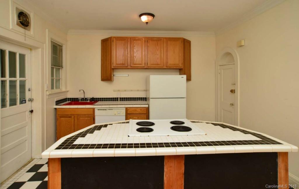 1237 Romany Road Charlotte, NC 28203 - Photo 4 of 15 a kitchen with a stove and a refrigerator