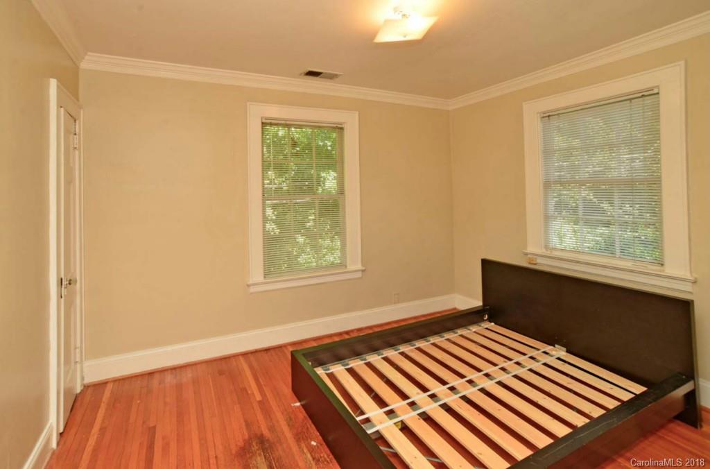 1237 Romany Road Charlotte, NC 28203 - Photo 8 of 15 a view of an empty room with wooden floor and a window