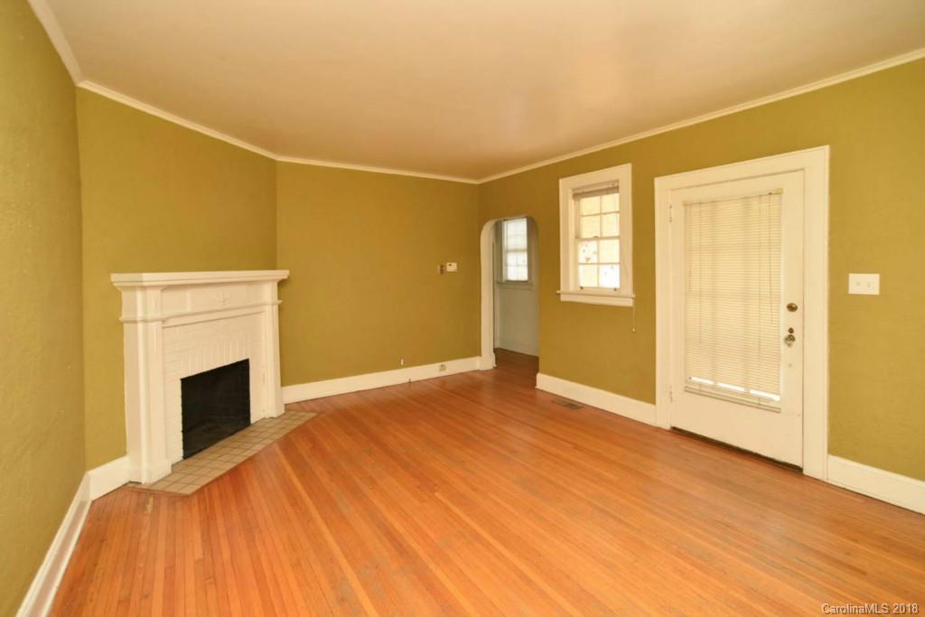 1237 Romany Road Charlotte, NC 28203 - Photo 10 of 15 a view of empty room with wooden floor and fireplace