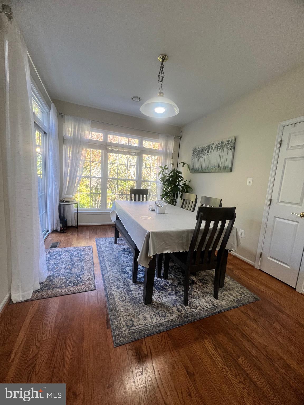 7317 Hampton Manor Place Springfield, VA 22150 - Photo 13 of 38 a view of a dining room with furniture window and wooden floor
