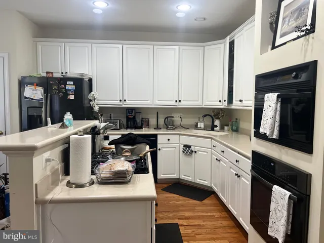 a kitchen with a sink dishwasher a stove and a refrigerator