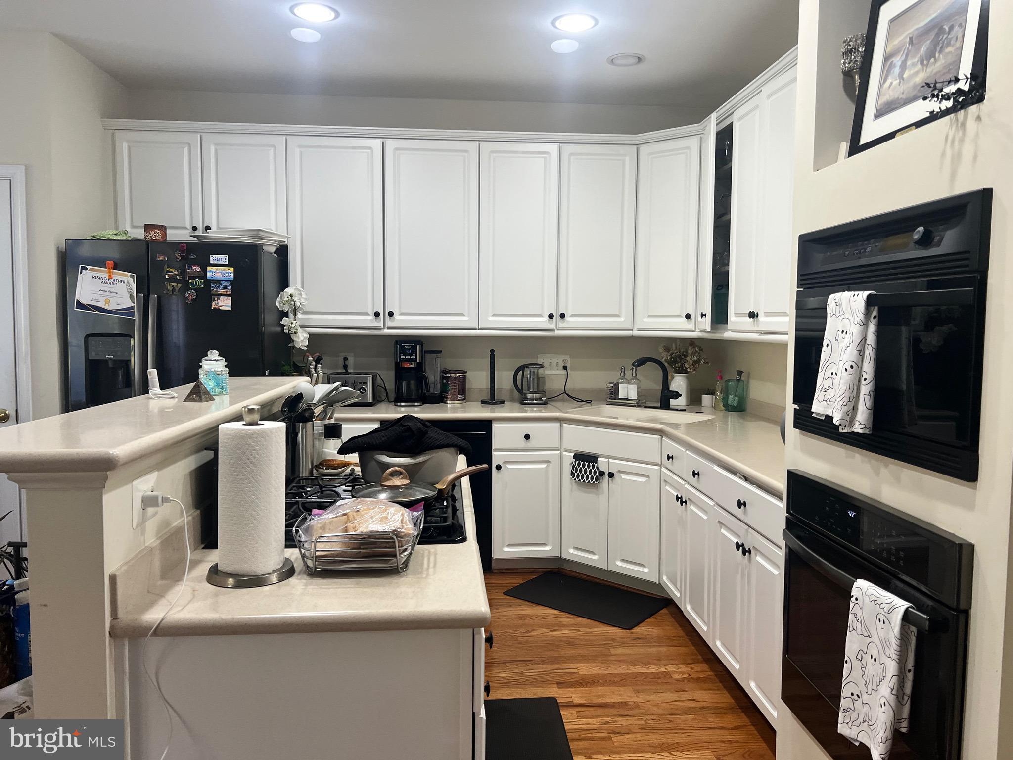 7317 Hampton Manor Place Springfield, VA 22150 - Photo 18 of 38 a kitchen with a sink dishwasher a stove and a refrigerator