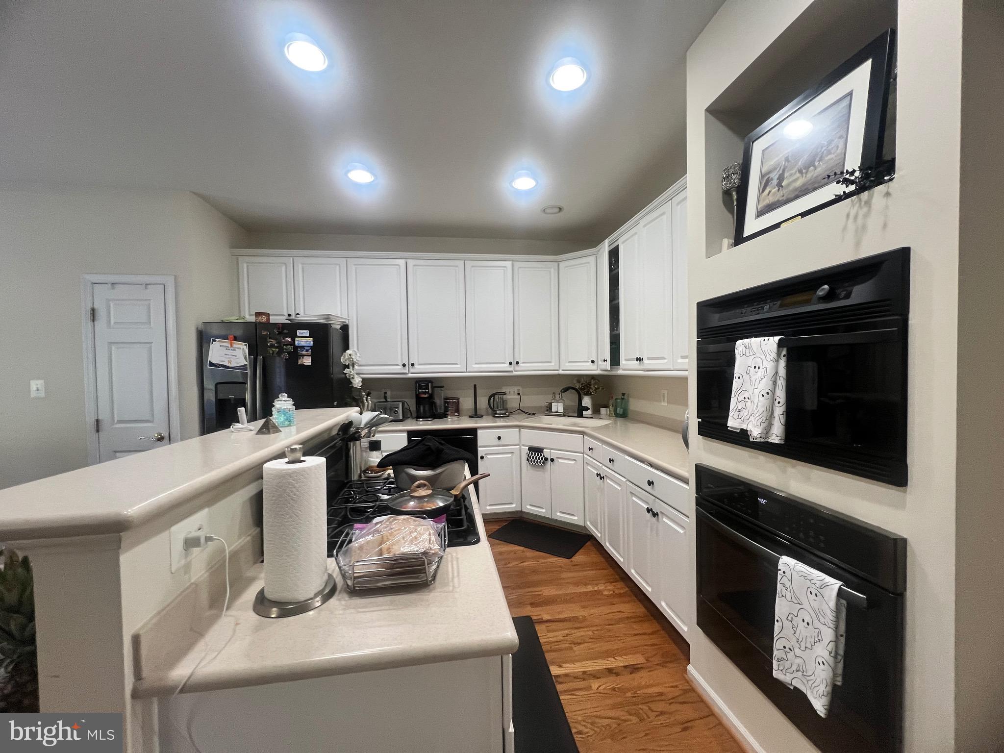 7317 Hampton Manor Place Springfield, VA 22150 - Photo 21 of 38 a kitchen with sink cabinets and microwave